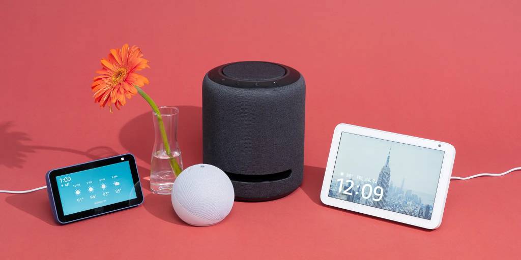 Voice assistant device like Amazon Echo issuing commands to connected bulbs and locks on a kitchen counter.