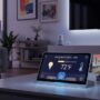 Smart home hub coordinating multiple connected devices including lights, thermostat, and security cameras in modern living room