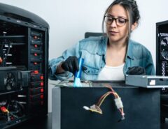 Person cleaning a desktop PC interior to remove dust and improve performance